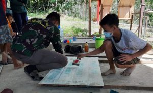 Satgas TMMD Bantu Pengecatan Papan Nama Digital Corner